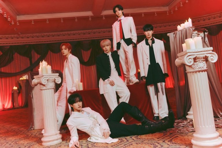 All five ONEUS members together in a vivid red color group photograph