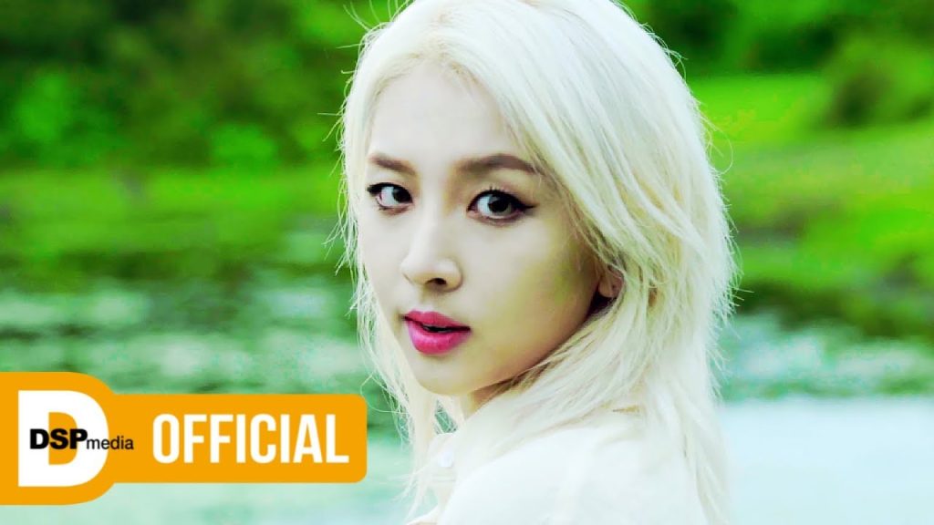KARD members BM, J.Seph, Somin and Jiwoo traveling through bright summer landscapes in the Ride on the Wind music video