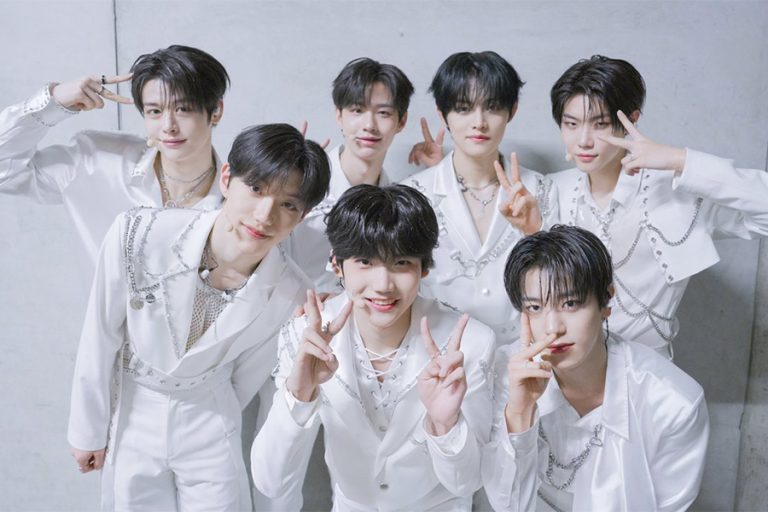 All seven CLOSE YOUR EYES members in white stage outfits