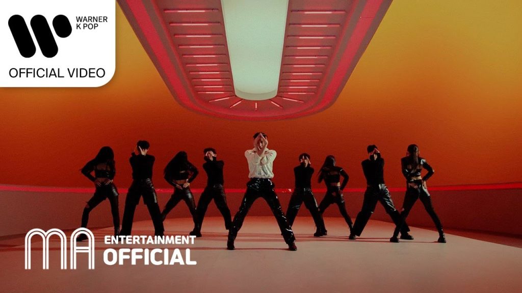 Moon Jongup dancing under moonlit lighting in the X.O.X music video.