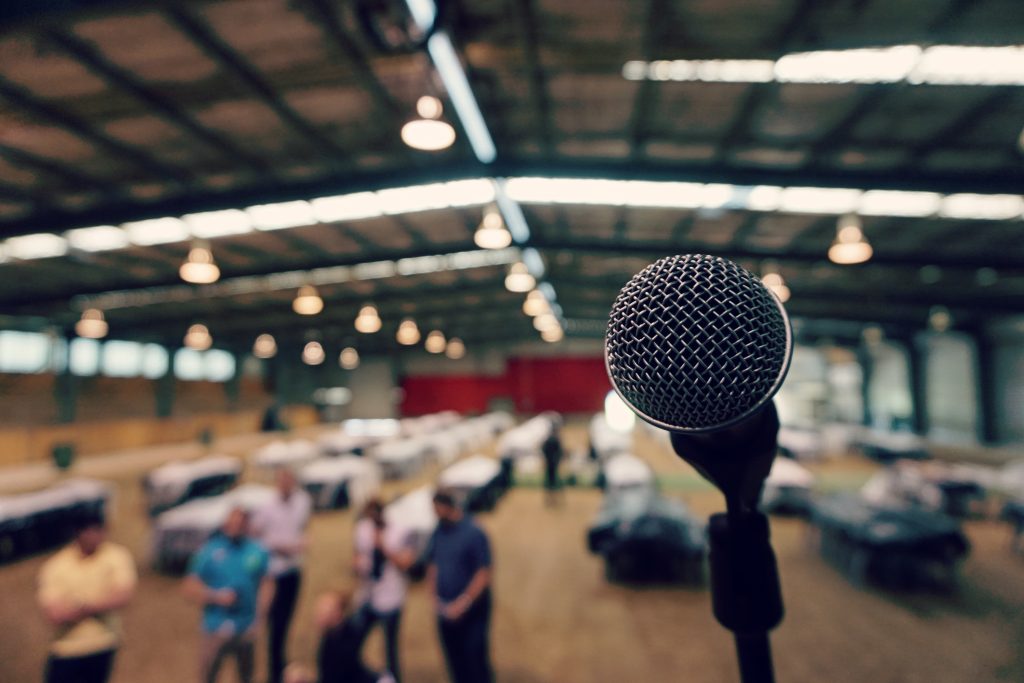 A real microphone waiting in a dark performance hall