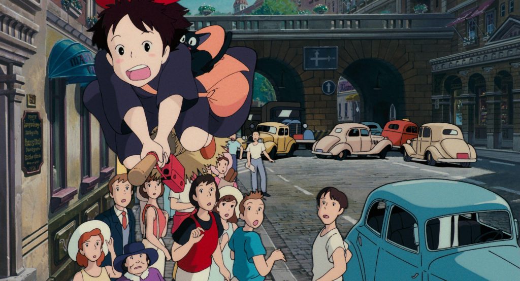 Kiki flying through Koriko above residents and city traffic