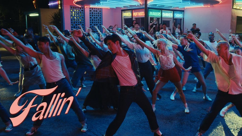 Mark Tuan performing in the retro Fallin official music video