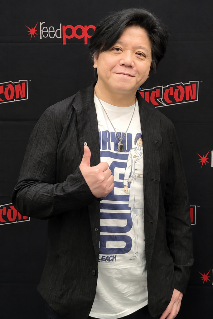 Japanese voice actor Noriaki Sugiyama at New York Comic Con wearing a BLEACH shirt