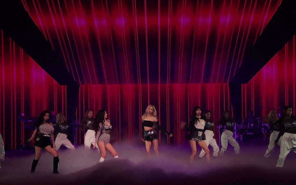 BLACKPINK performing Pretty Savage on a red-lit stage