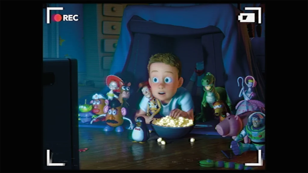 Young Andy watching television surrounded by Woody, Buzz, Jessie, and his conscious toys