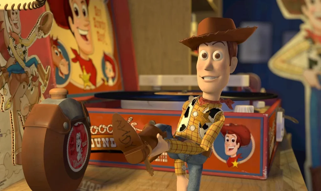Woody lifting his boot to show Andy’s handwritten name inside the Woody’s Roundup collection