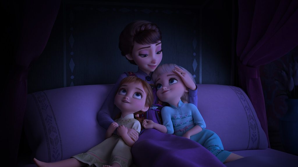 Queen Iduna hugging young Anna and Elsa in an official Frozen II still