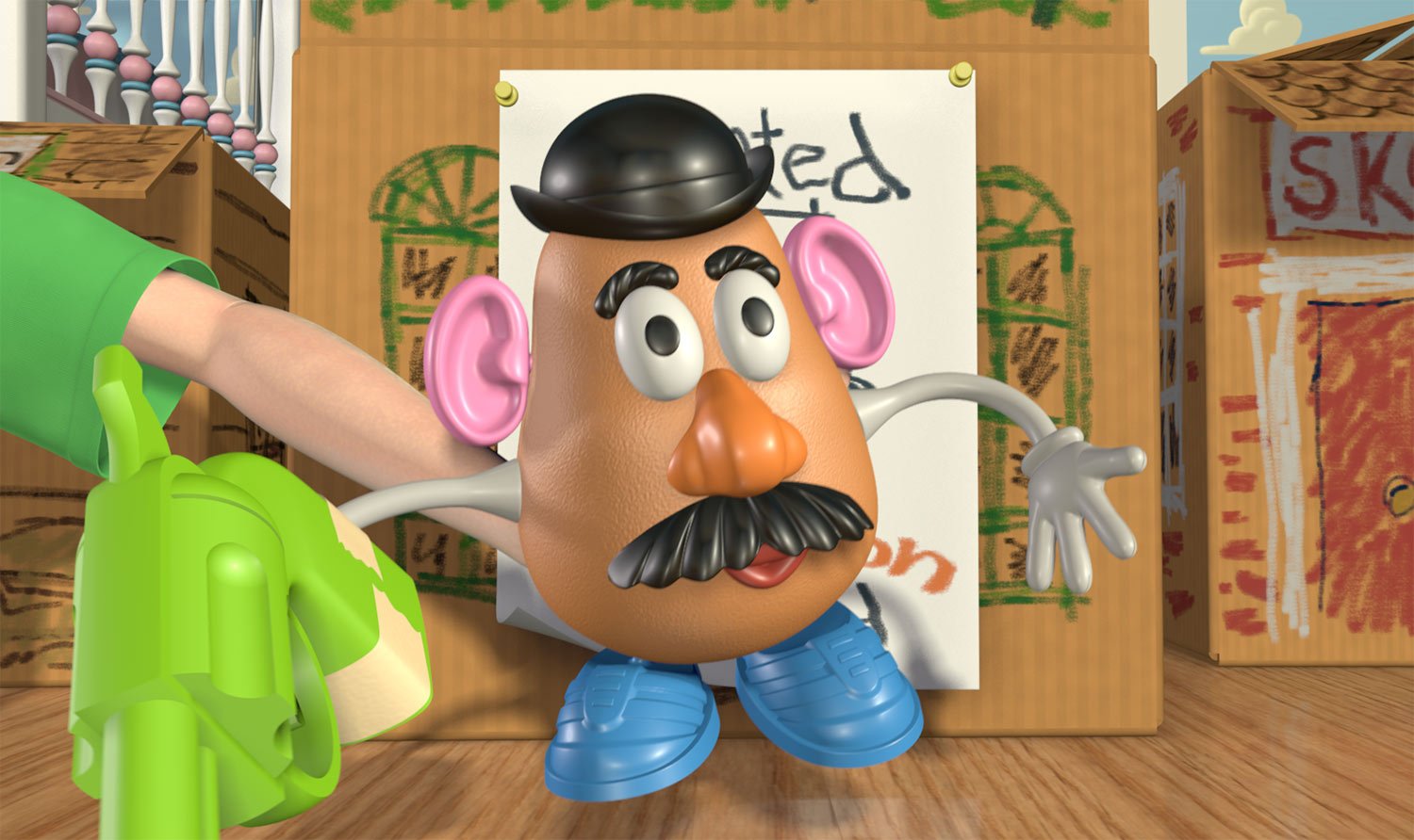 Mr. Potato Head standing beside a green toy during Andy’s imaginative play