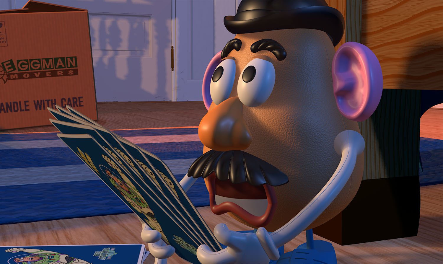 Mr. Potato Head reading an instruction booklet in Andy’s room