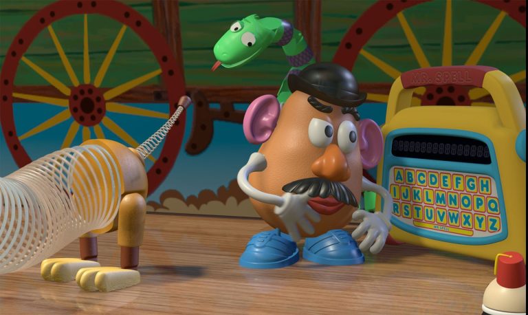 Mr. Potato Head standing with Slinky, Mr. Spell, and another toy in an official Toy Story image