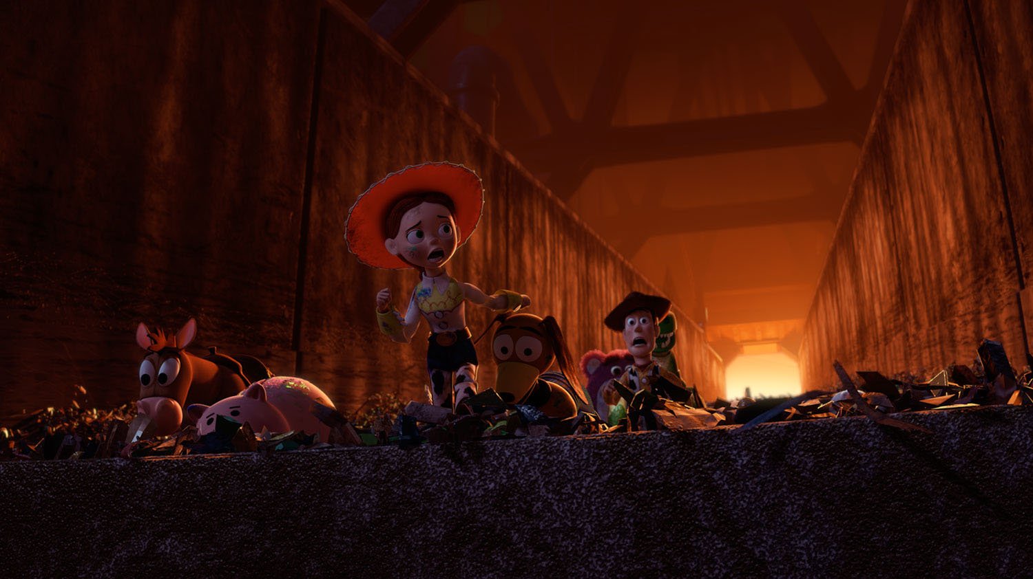 Woody, Jessie, Bullseye, and the toys running through the Toy Story 3 landfill